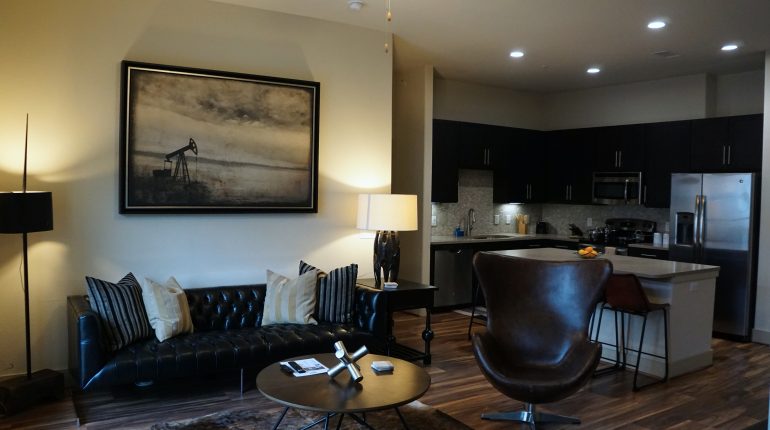 Living room with couch and coffee table, from the Texas design at Premier Patient Housing.