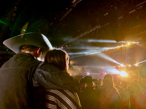 Couple watching concert at rodeo.
