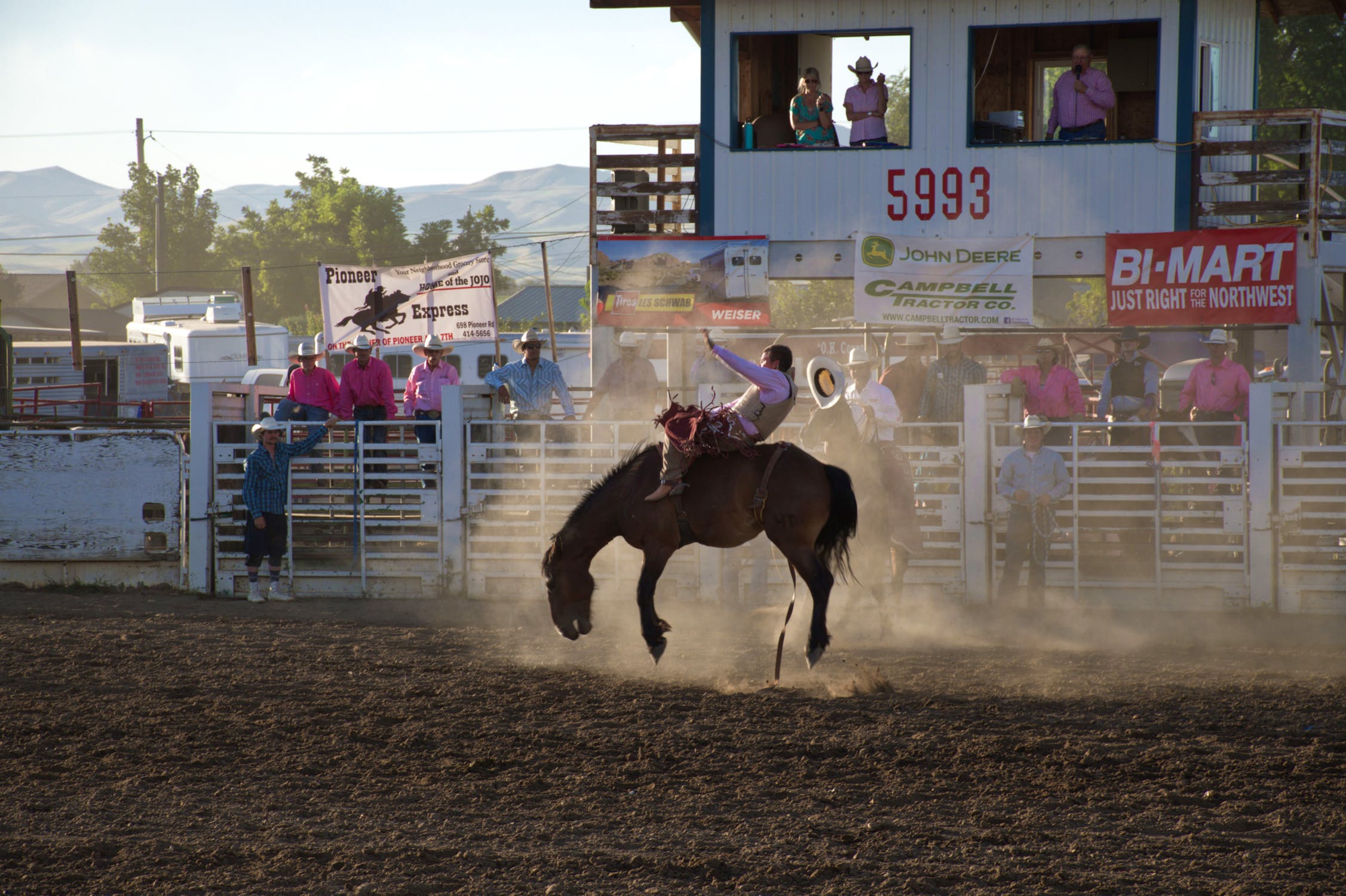 Cowboy bronco riding mid buck.