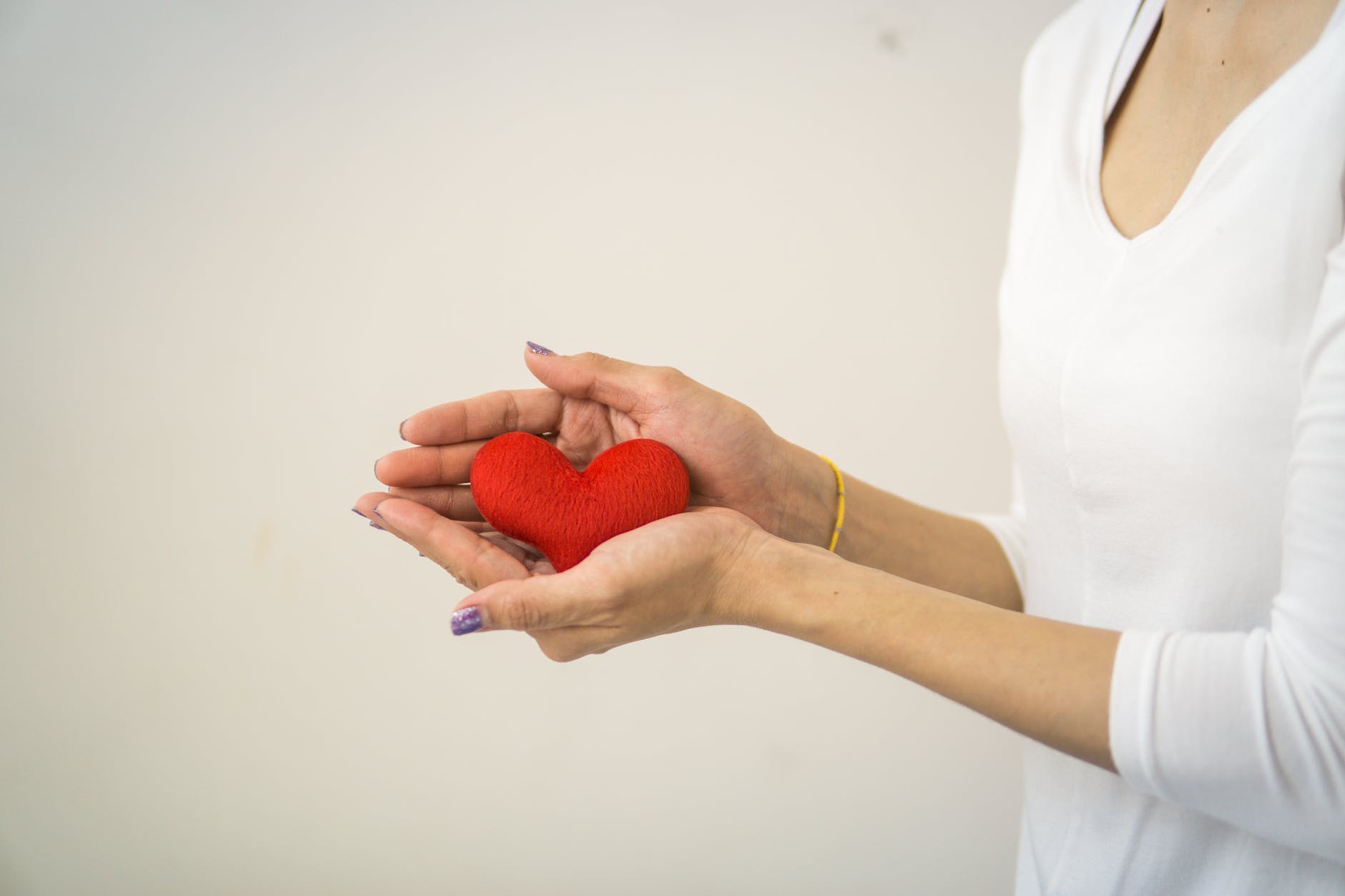woman holding a fabric heart