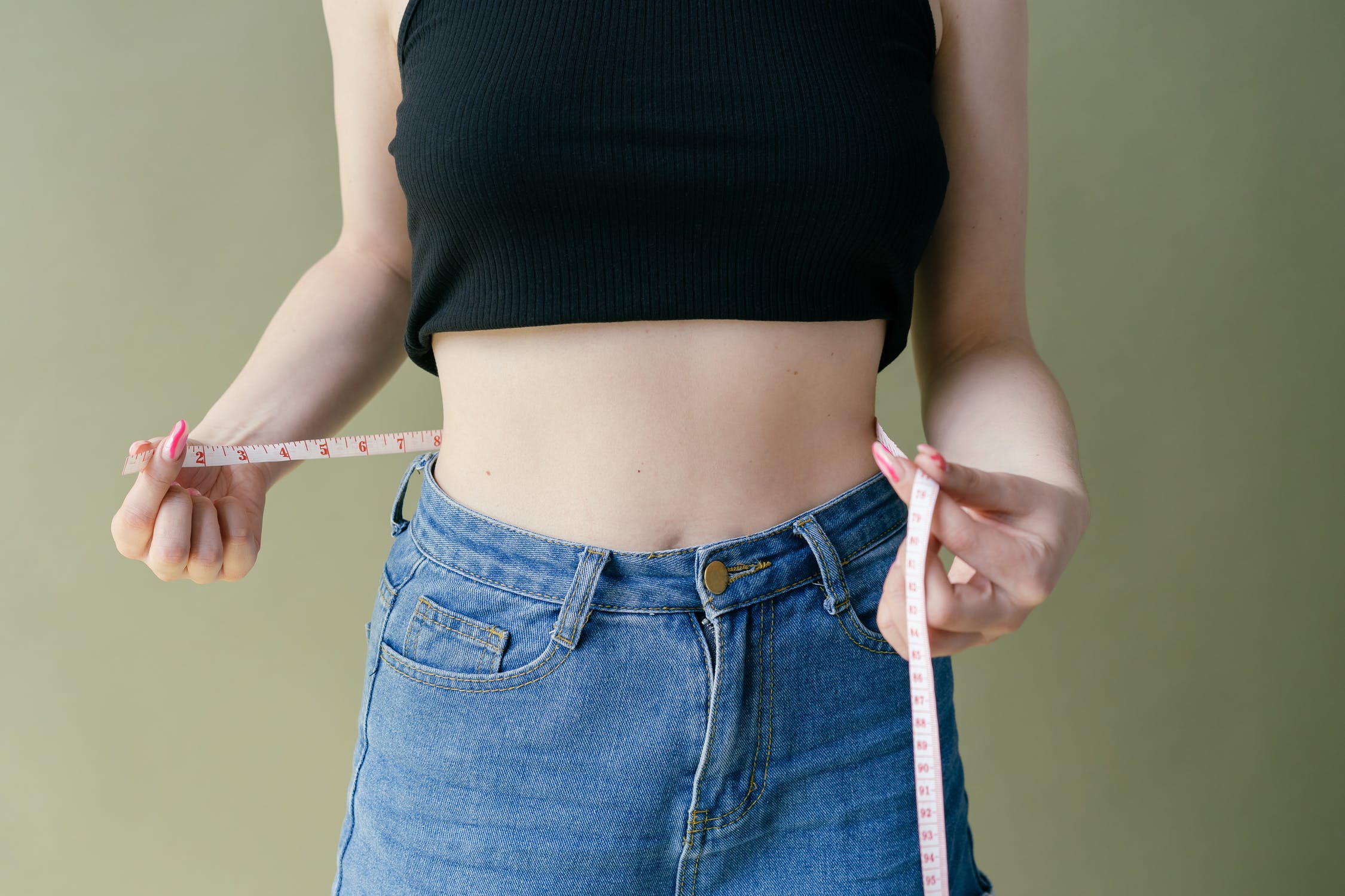 woman with measuring tape around waist