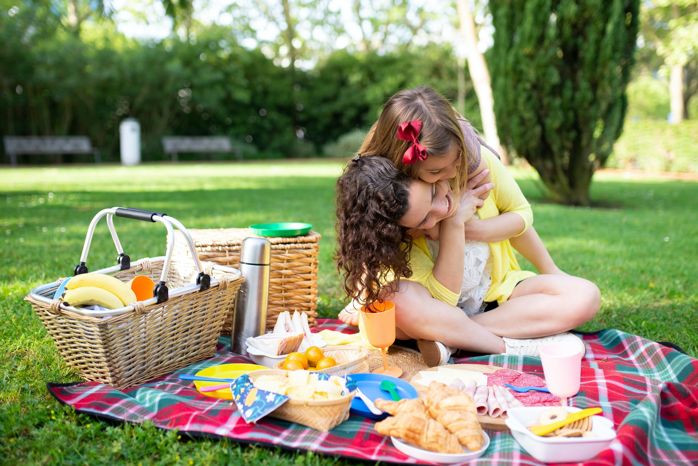 child hugging mother at picnic