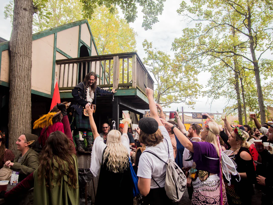 Renaissance festival attendees cheering